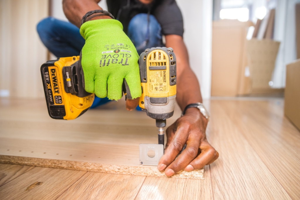 A person using a hand drill for a home renovation project