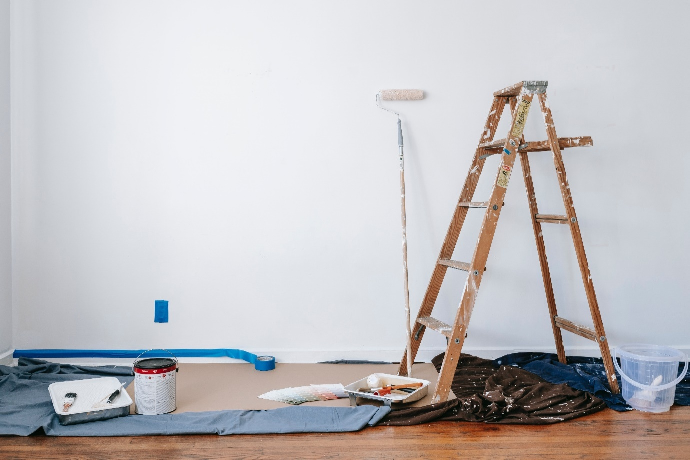 A wooden ladder with painting supplies for DIY home renovation