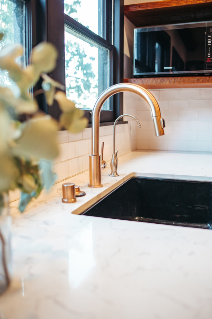 A golden tap near a kitchen sink